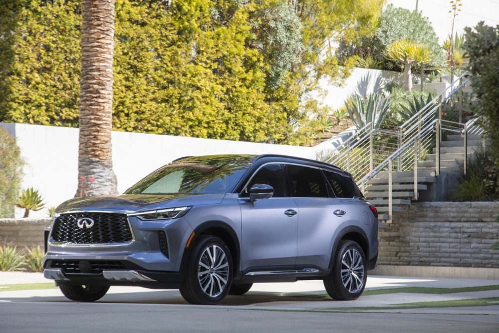 2022 INFINITI QX60 in front of a staircase and ivy-lined wall