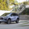 2022 INFINITI QX60 in front of a staircase and ivy-lined wall