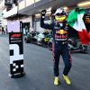 Perez celebrates after the race, holding Mexican flag