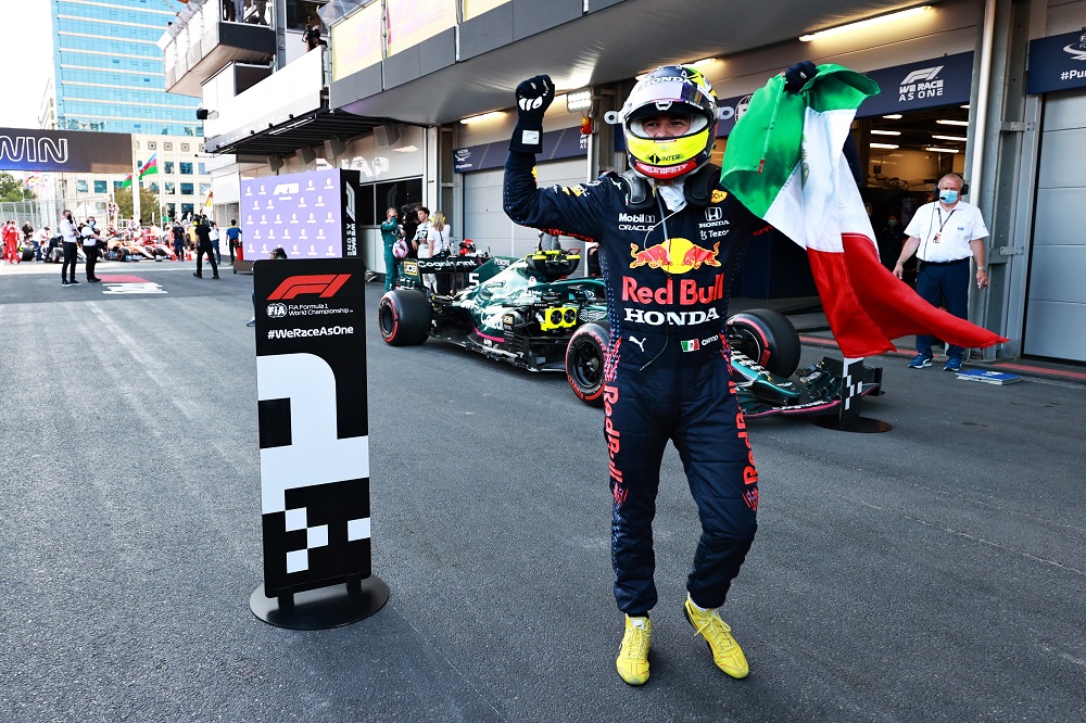 Perez celebrates after the race, holding Mexican flag