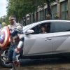 Still photo from ad: Captain America holds shield while standing next to 2022 Hyundai Tucson