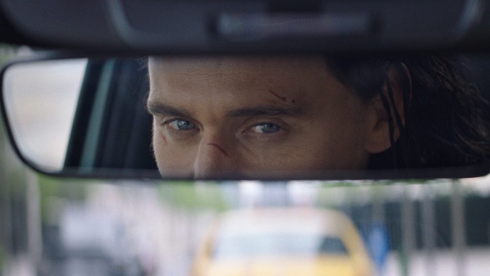 Ad still: Loki's eyes are reflected in 2022 Hyundai Tucson rearview mirror