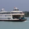 Car fransport ferry shipping vehicle across a body of waterg