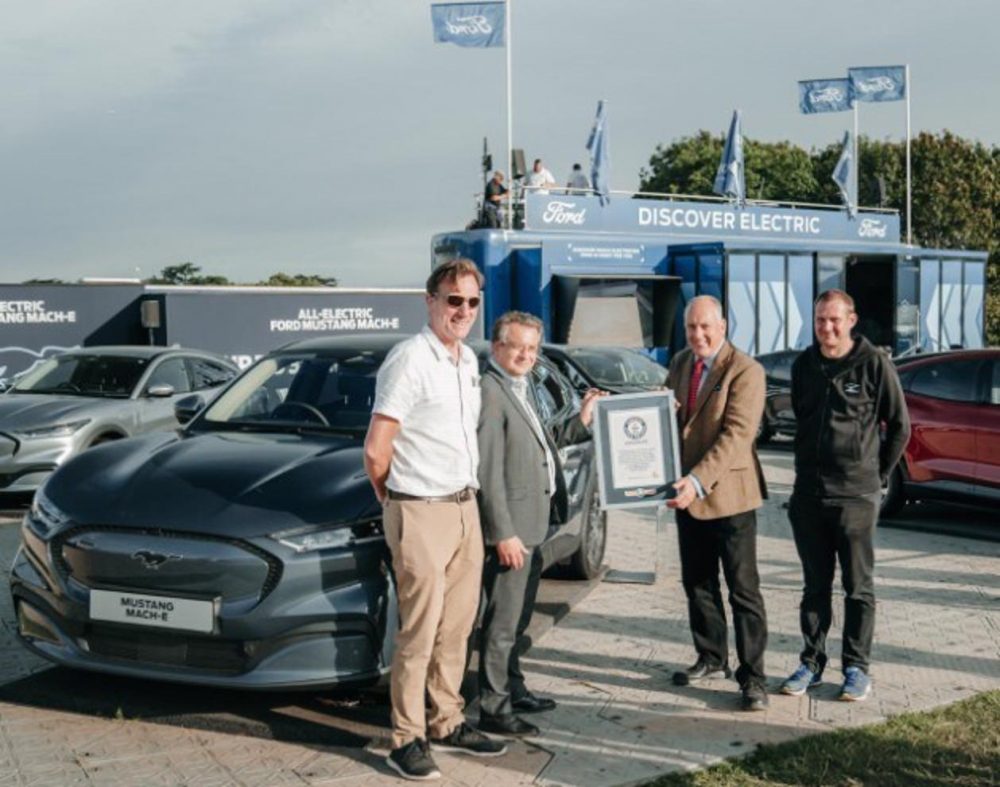 Representatives from Ford and Guinness World Records commemorate the Mustang Mach-E setting a record for least energy consumed by an electric vehicle