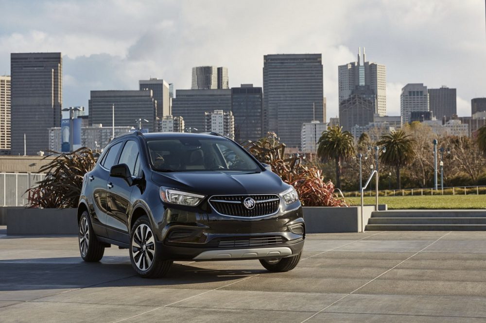 Front side view of 2022 Buick Encore against city skyline