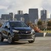 Front side view of 2022 Buick Encore against city skyline