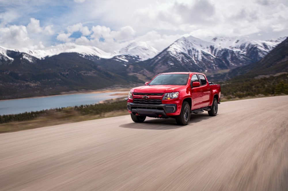 The 2022 Chevrolet Colorado Trail Boss driving on the road with mountains in the background