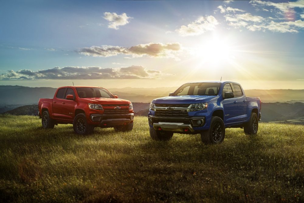 Two 2022 Chevrolet Colorado Trail Boss models in a field