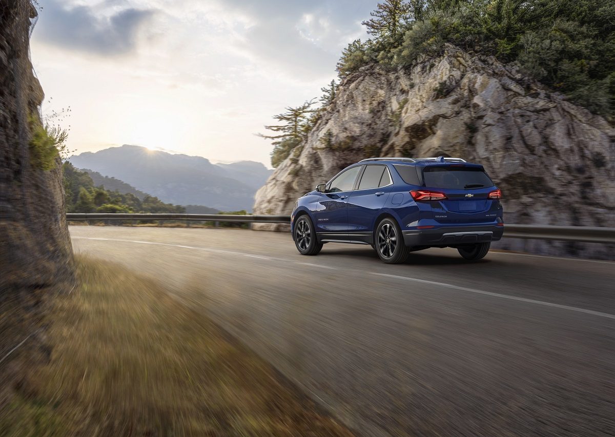 Rear side view of 2022 Chevrolet Equinox Premier driving down road