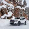 2022 GMC Terrain AT4 parked by a snow-covered rocky outcropping