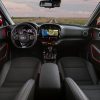 2022 Kia Soul interior in black with red accents and the 10.25-inch touch screen display lit up