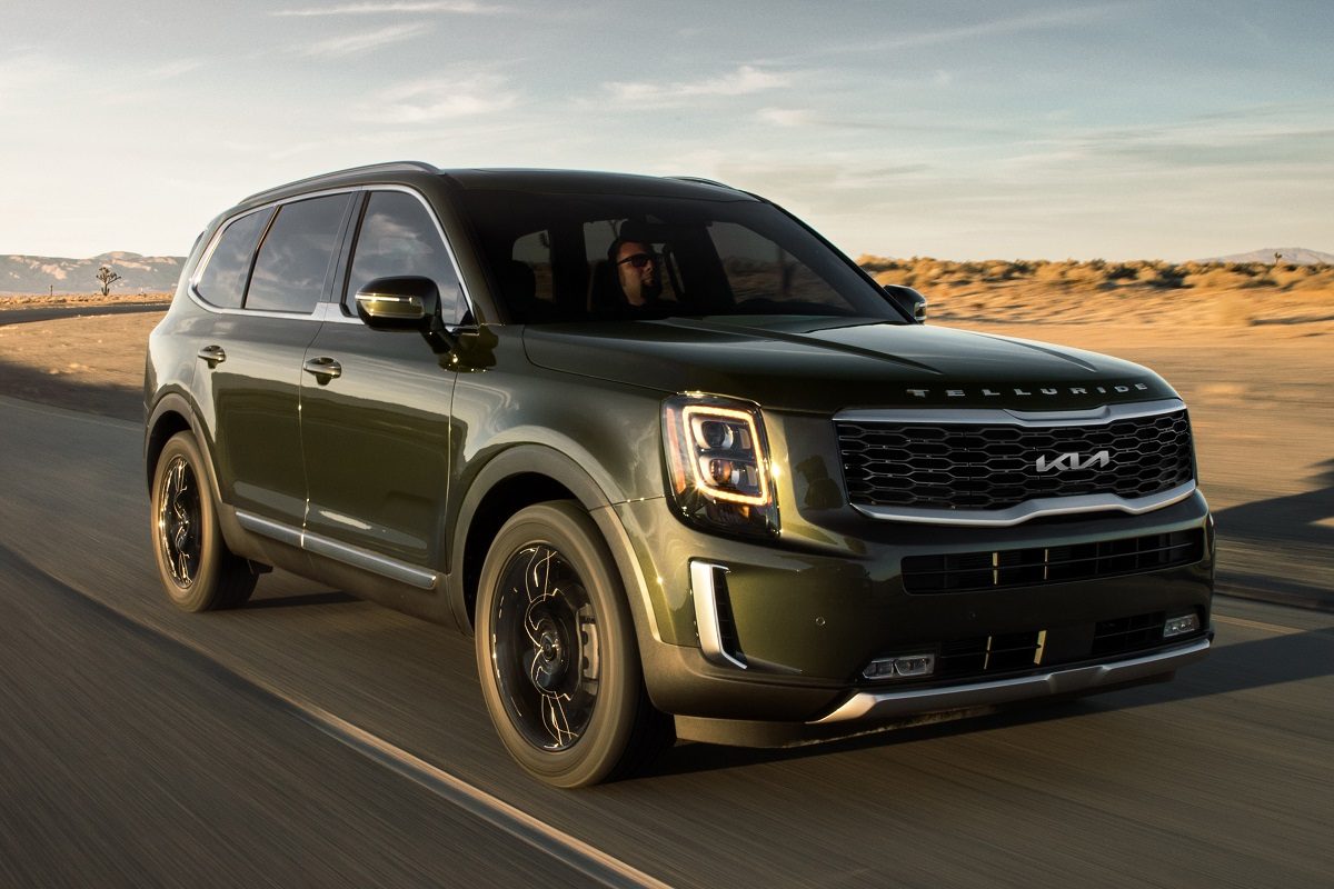 Exterior front photo of 2022 Kia Telluride driving on a desert highway