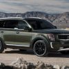 Exterior side photo of 2022 Kia Telluride driving on a desert road