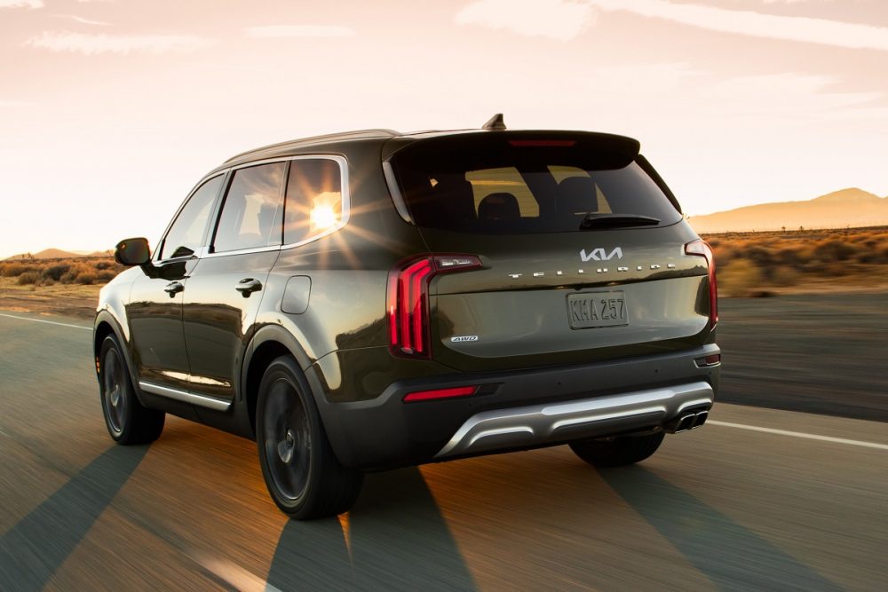 Exterior rear photo of 2022 Kia Telluride driving on a desert highway