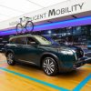 Sideview of 2022 Nissan Pathfinder with bicycle attached to roof rack in Nissan Studio in Canada