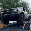 A 2021 Ford Bronco demonstrating its performance on uneven terrain at the Built Wild Bronco mountain experience at the 2021 Chicago Auto Show