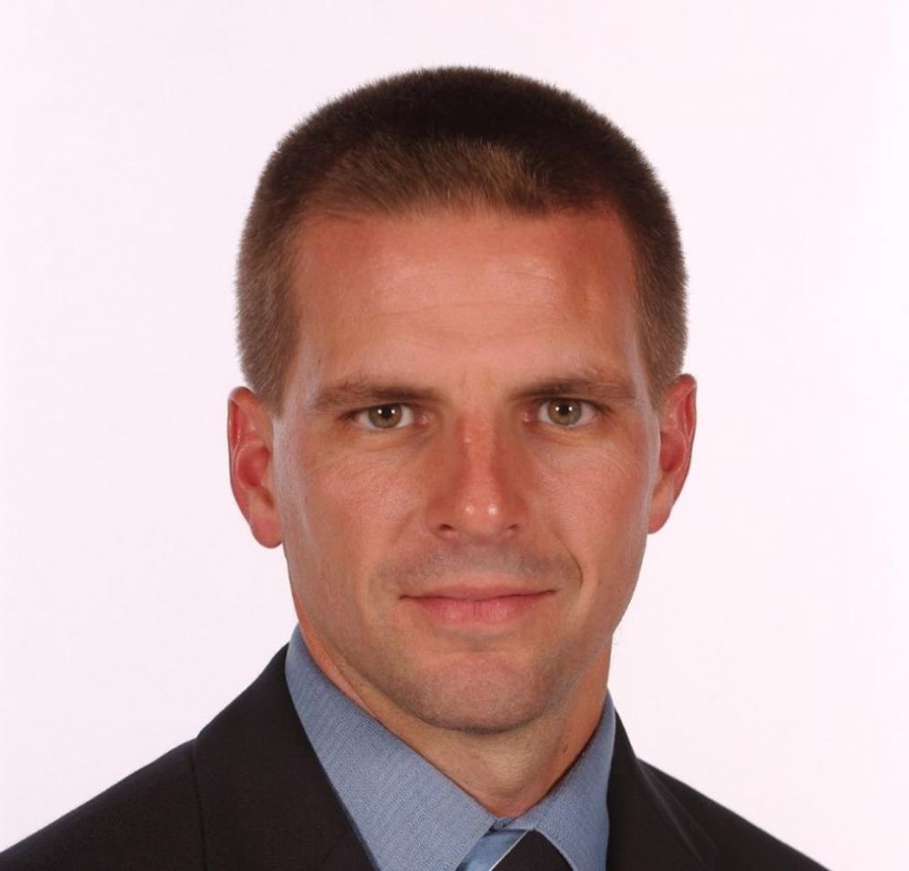 A cropped headshot of Ford Chief Policy Officer Steven Crowley