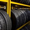 A yellow metal rack holding unused tires