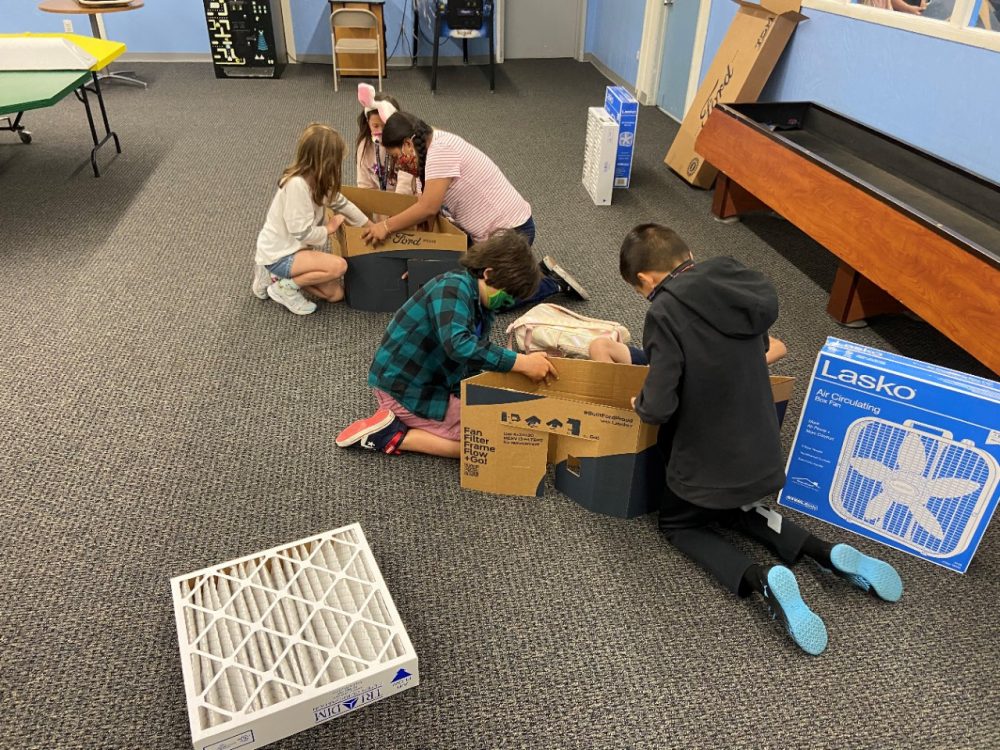 Kids at the Boys and Girls Club South Coast Area constructing a Ford Scrappy Filtration kit