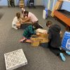 Kids at the Boys and Girls Club South Coast Area constructing a Ford Scrappy Filtration kit