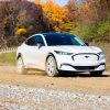 A hero shot of the 2021 Ford Mustang Mach-E testing on a gravel road