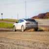 A rear quarter shot of the 2021 Ford Mustang Mach-E testing on a gravel road