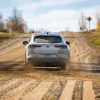 A rear shot of the 2021 Ford Mustang Mach-E testing on a gravel road