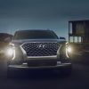 Front view of 2021 Hyundai Palisade at night with LED headlights shining