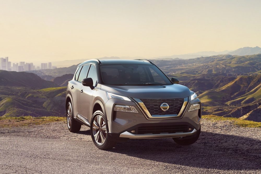 2021 Nissan Rogue in silver parked atop a hill