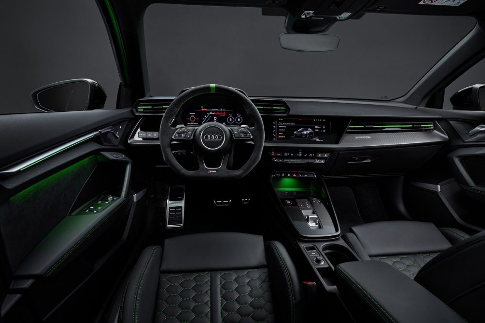 Interior view of the 2022 Audi RS 3's front seat area, with a focus on the steering wheel and dash