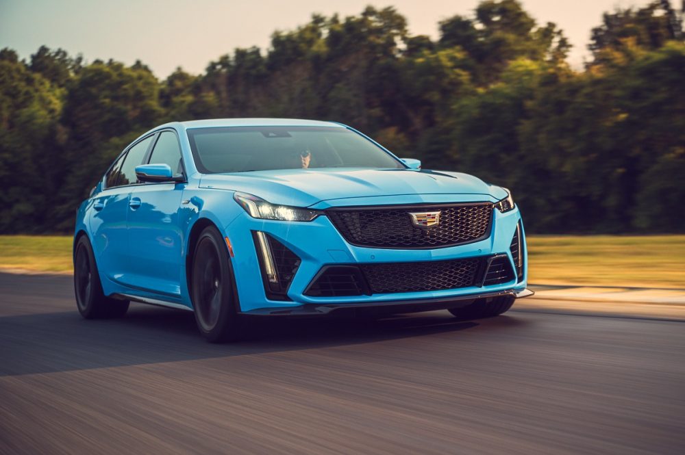 Front side view of light blue 2022 Cadillac CT5-V Blackwing driving on track