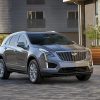 Front exterior view of a gray 2022 Cadillac XT5 parked in front of a building