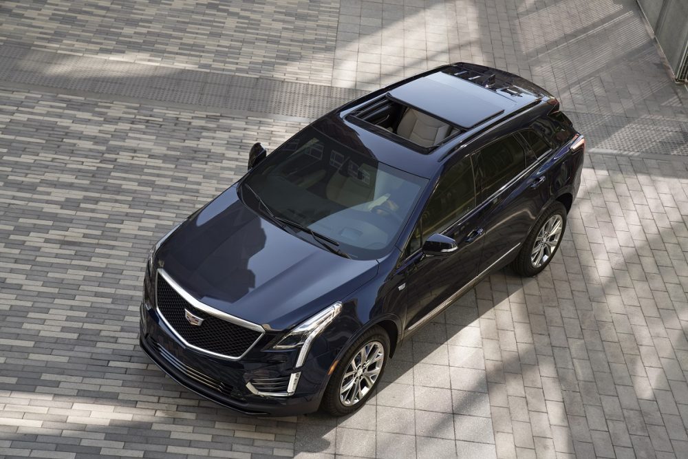 Aerial view of a dark blue 2022 Cadillac XT5 with its sunroof open