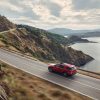 2022 Ford Explorer ST-Line racing along a mountain road overlooking a lake