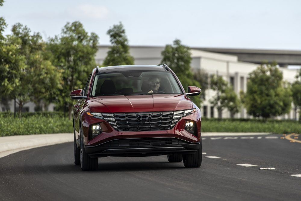 Front view of 2022 Hyundai Tucson driving down road