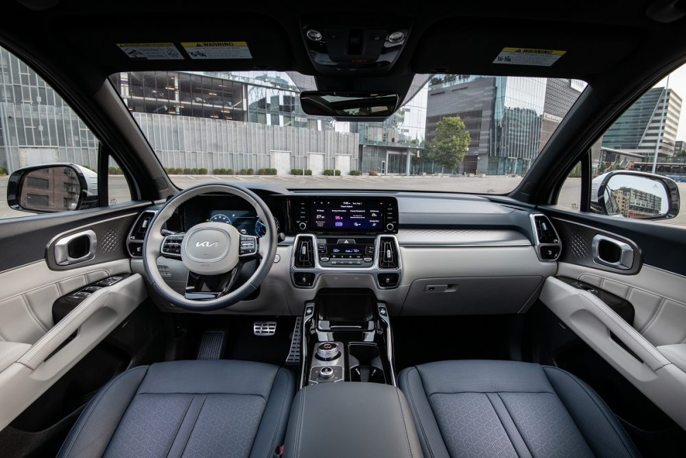 Interior view of the 2022 Kia Sorento PHEV, showcasing the dash, steering wheel, and front seats