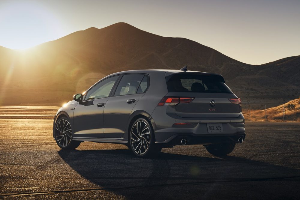 Rear exterior view of the 2022 Volkswagen Golf GTI parked with mountains behind