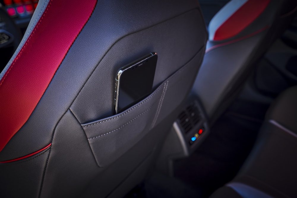 Close up of the interior seatback pocket of the 2022 Volkswagen Golf GTI with a smartphone in the pocket