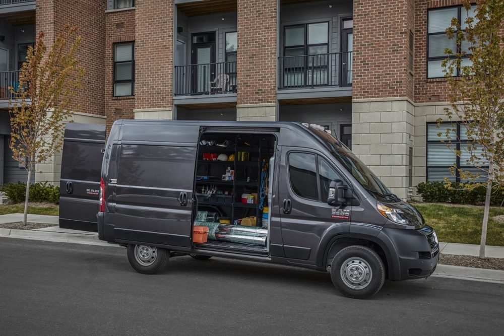 The 2022 Ram ProMaster 3500 parked on the street with a side door open