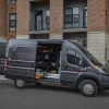 The 2022 Ram ProMaster 3500 parked on the street with a side door open