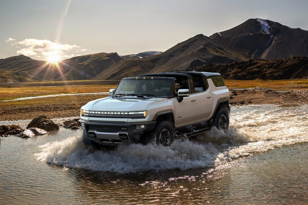 Front view of a white 2024 GMC Hummer EV SUV fording water