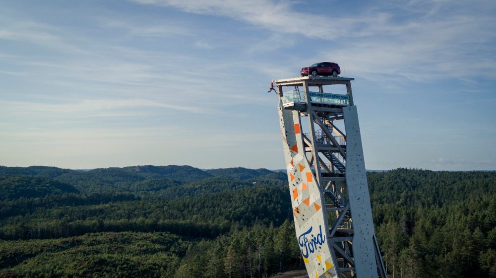 A Ford Explorer Plug-In Hybrid rests atop the OVER climbing tower in Norway, the tallest free-standing climbing structure on Earth