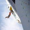 A climber hangs off the side of the OVER climbing tower in Norway