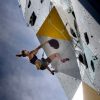 A climber hangs off the side of the OVER climbing tower in Norway