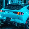 Rear shot of the Ford Mustang Mach-E undergoing paint testing in a car wash