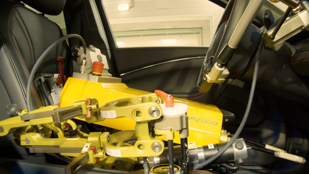 Ford's test driver robot in the driver's seat of a vehicle