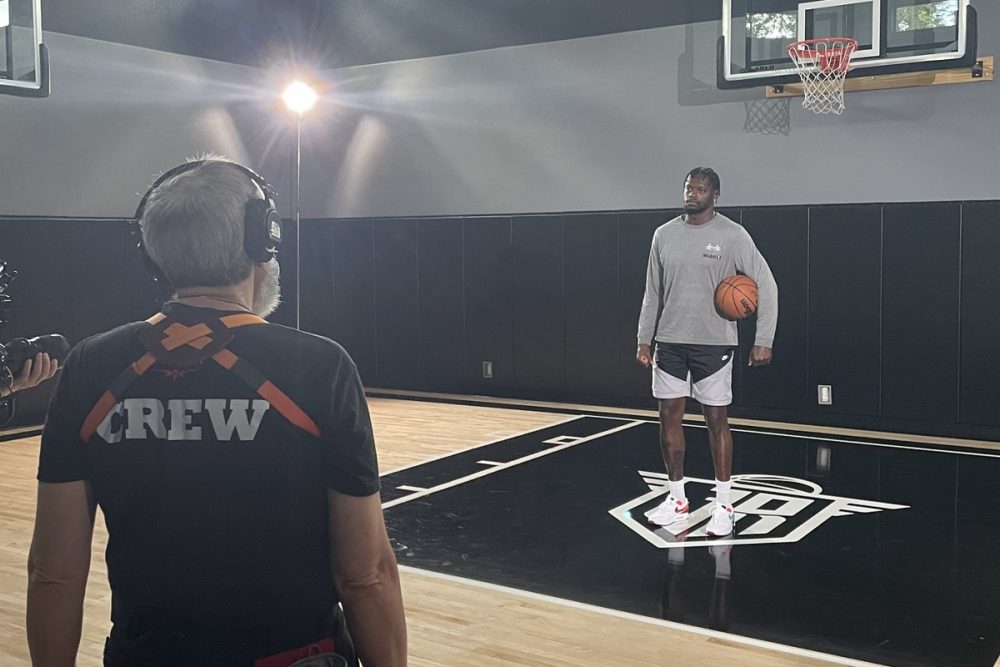 New York Knicks player Julius Randle poses on a court with a basketball under his left arm