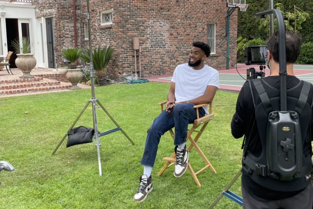 Minnesota Timberwolves player Karl-Anthony Towns sits in a chair and gets interviewed by Bleacher Report