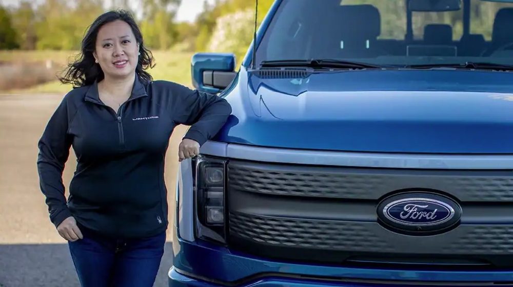 Linda Zhang, 2022 Ford F-150 Lightning Chief Engineer, standing next to an F-150 Lightning