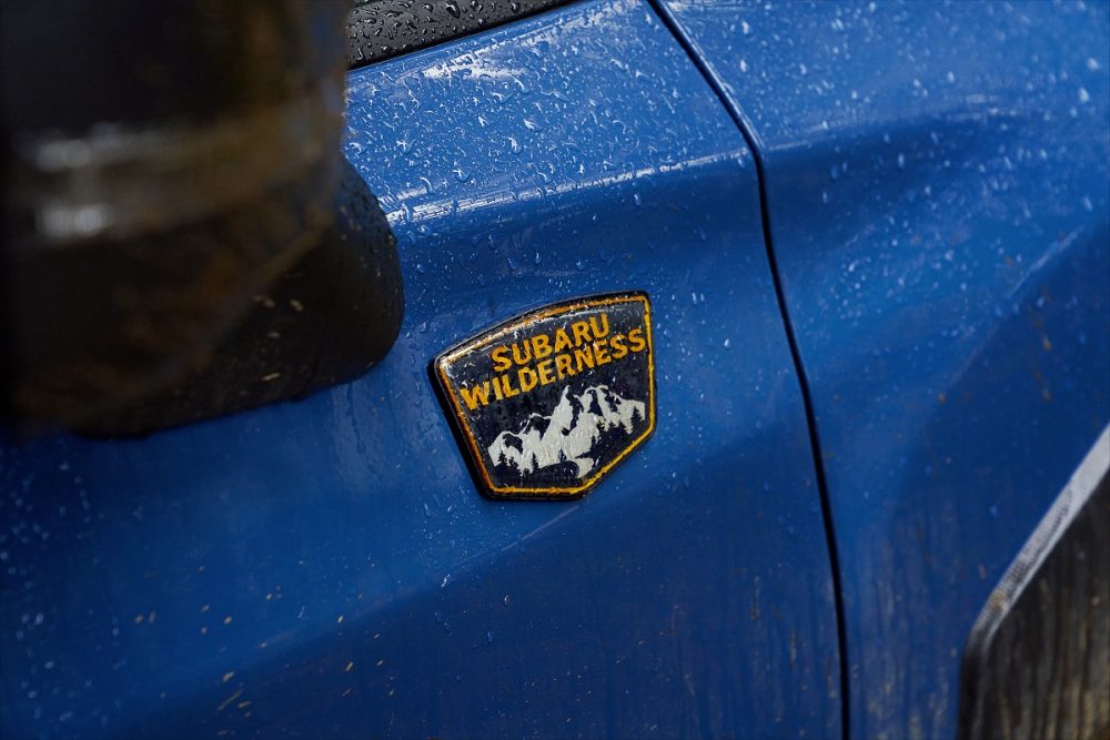 Close up of the Subaru Wilderness badge on an unknown blue Subaru model